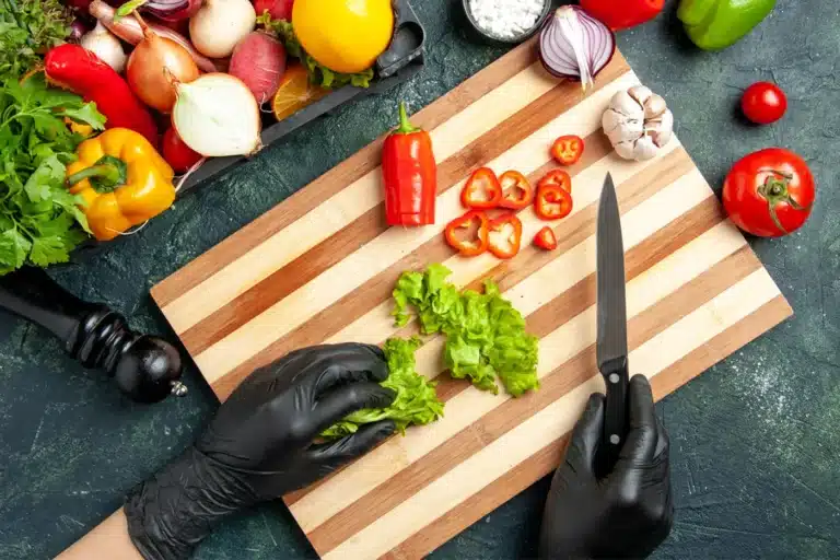 Culinary PPE worn by chefs in a commercial kitchen to ensure food safety and hygiene.